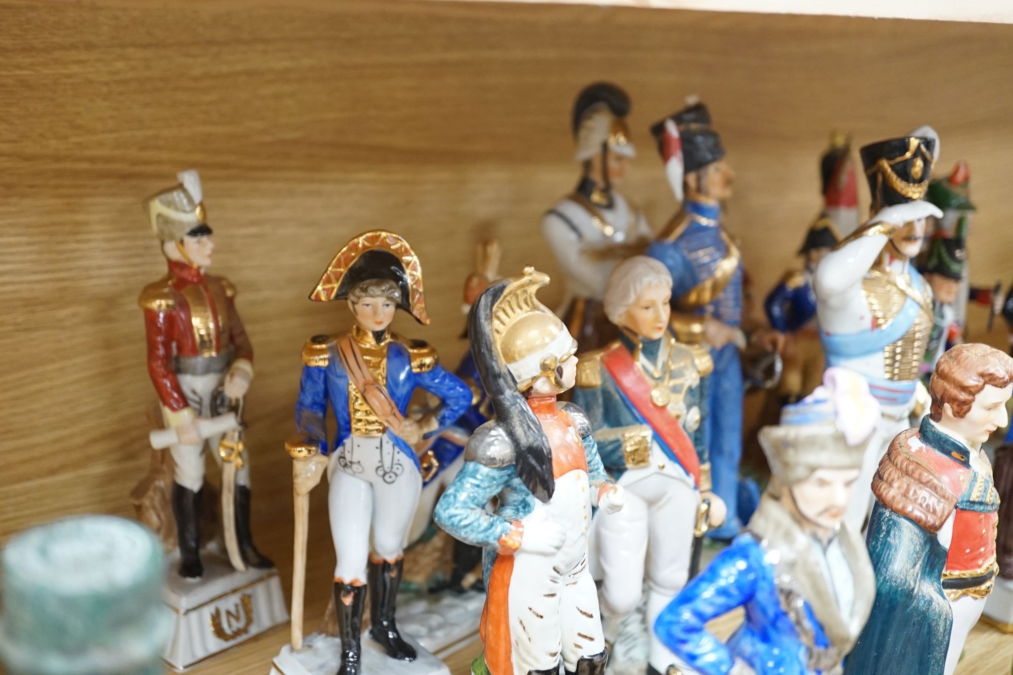 A collection of Continental porcelain figures of military soldiers, tallest 27.5cm